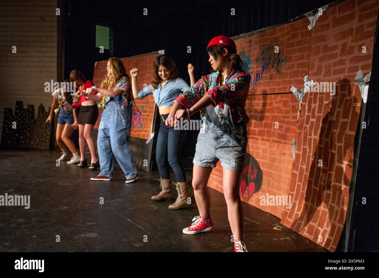 Multiracial high school girls dance at a fashion show as they model self-made clothing in Mission Viejo, CA Stock Photo