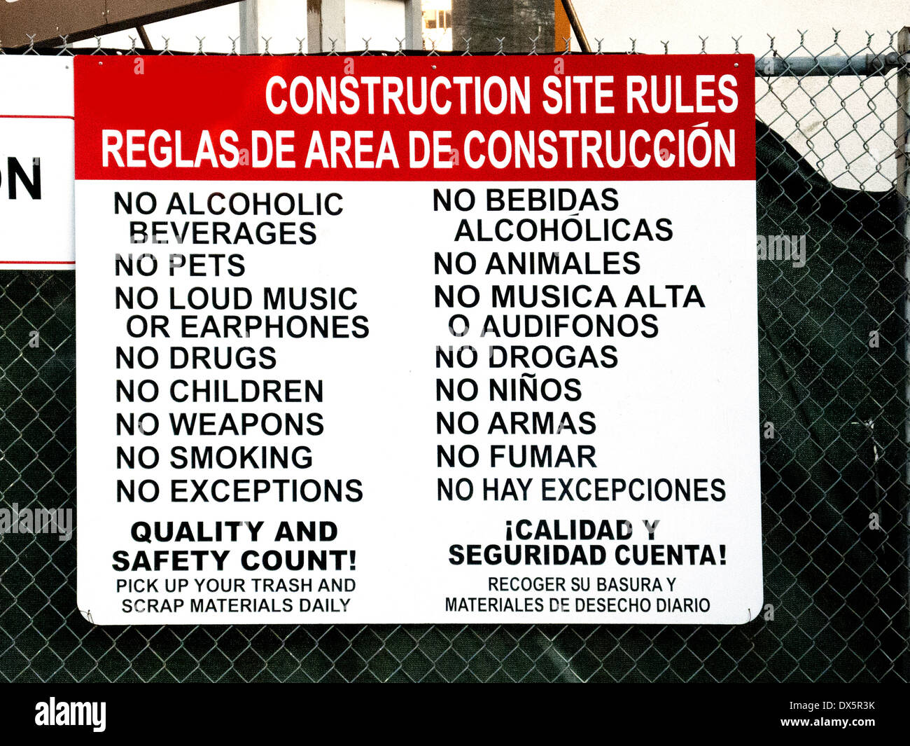 A sign in both English and Spanish lists safety rules at a Los Angeles construction site. Stock Photo