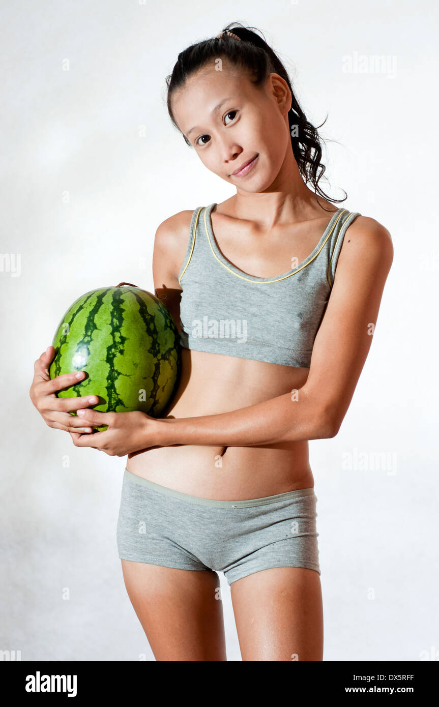 young Asian body shape model with watermelon in studio setting Stock Photo  - Alamy
