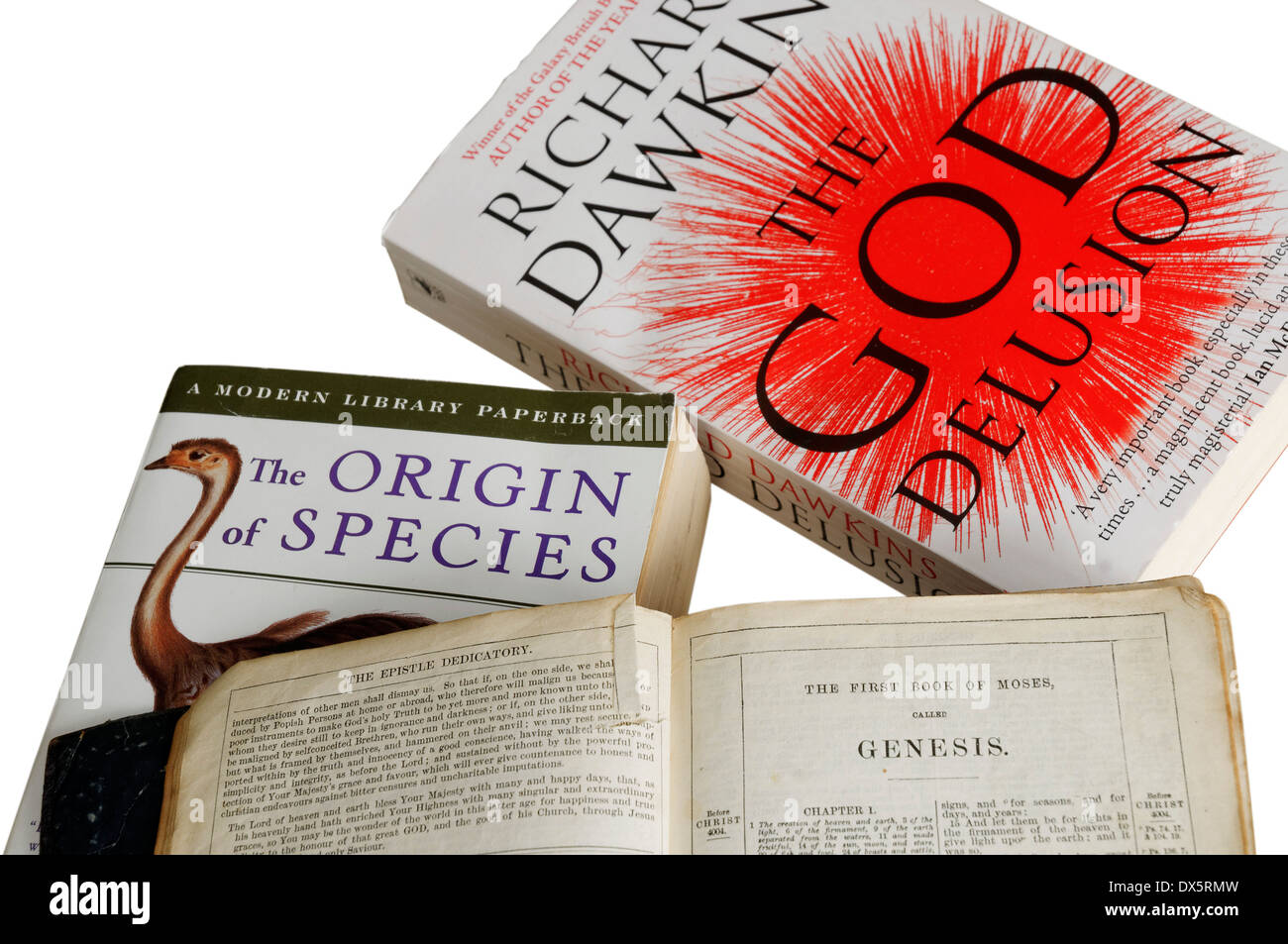 Atheism and Theism: The Origin of Species by Darwin, The God Delusion by Dawkins and the bible open at the  book of genesis Stock Photo