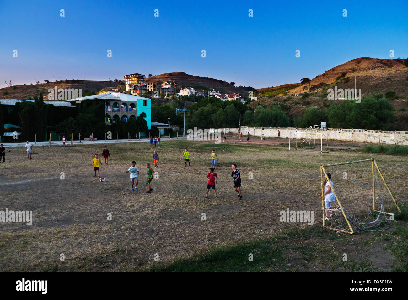 Children play soccer near the seaside in Crimea, Ukraine Stock Photo