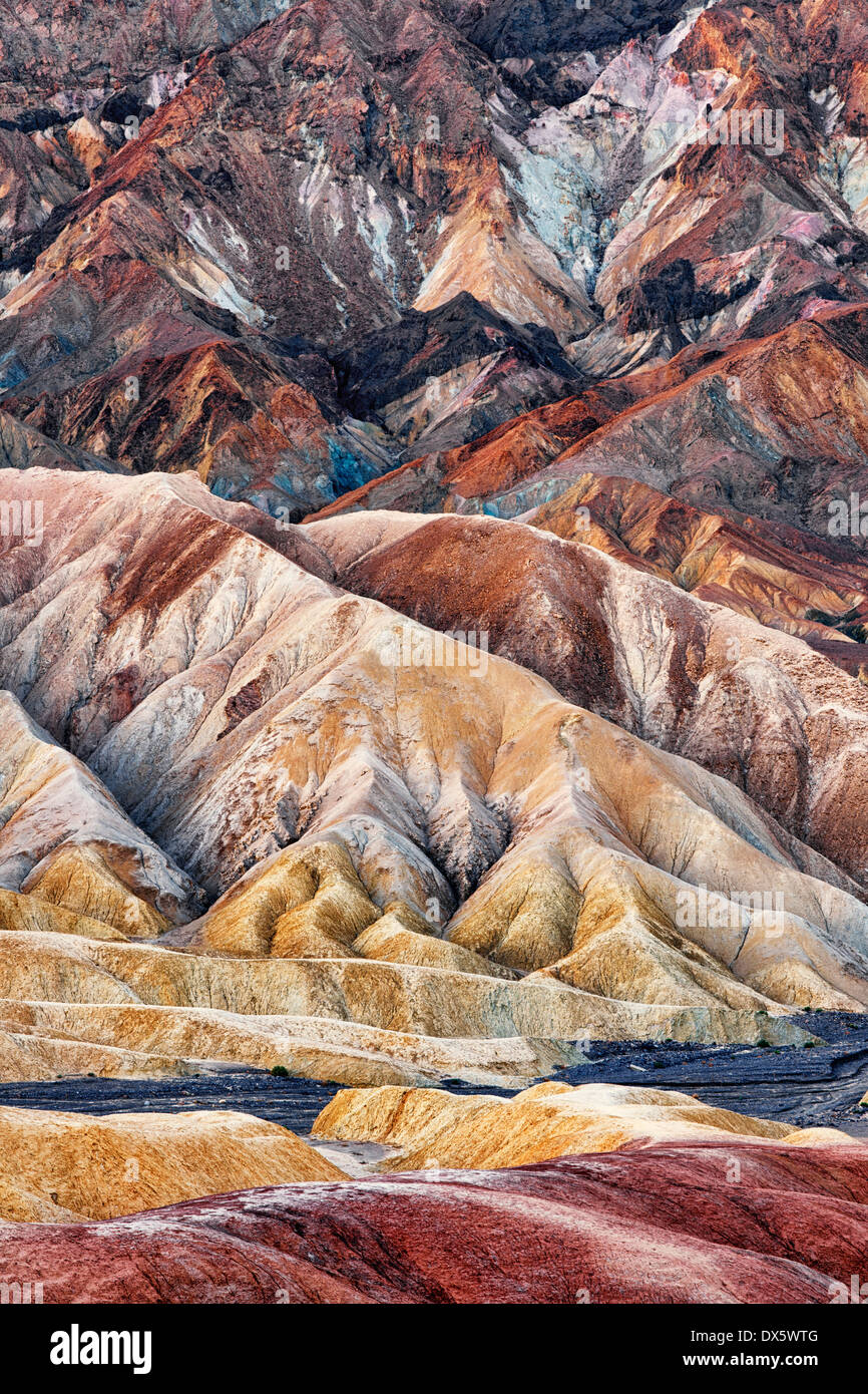 Civil twilight enhances the spectacular colors of the Golden Canyon Badlands in California's Death Valley National Park. Stock Photo