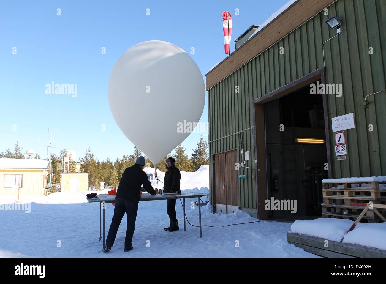 Sodankyla, Finland. 18th Mar, 2014. Researchers prepare for launching a sounding balloon in Sodankyla, Finland on March 18, 2014. In an effort to carefully monitor the ozone depletion in the Arctic area, the Arctic Research Center of Finnish Meteorological Institute, located in Sodankyla, northern Finland, has increased the frequency of launching sounding balloons. Credit:  Li Jizhi/Xinhua/Alamy Live News Stock Photo