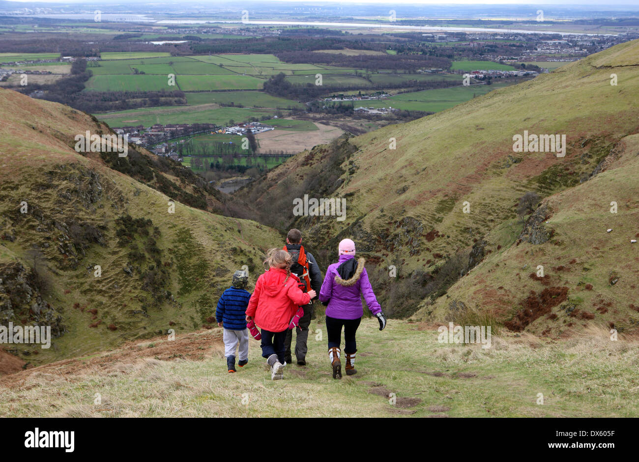 Family descending The Law (2094 ft) in the Ochil hills with Tillicoultry just visible to the below the ridge to the left. Stock Photo