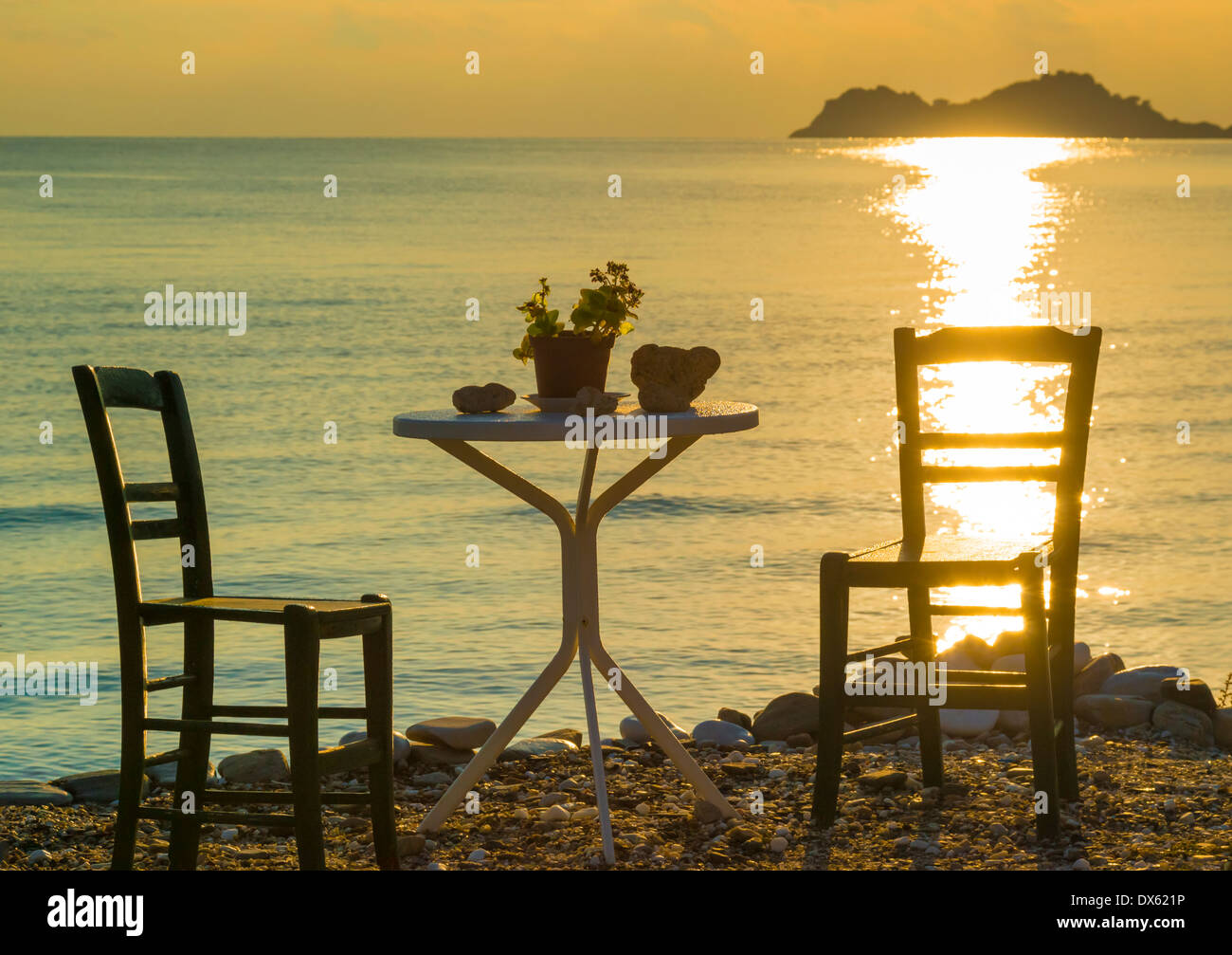 Two empty chairs and a table standing lonely in the peaceful sunshine