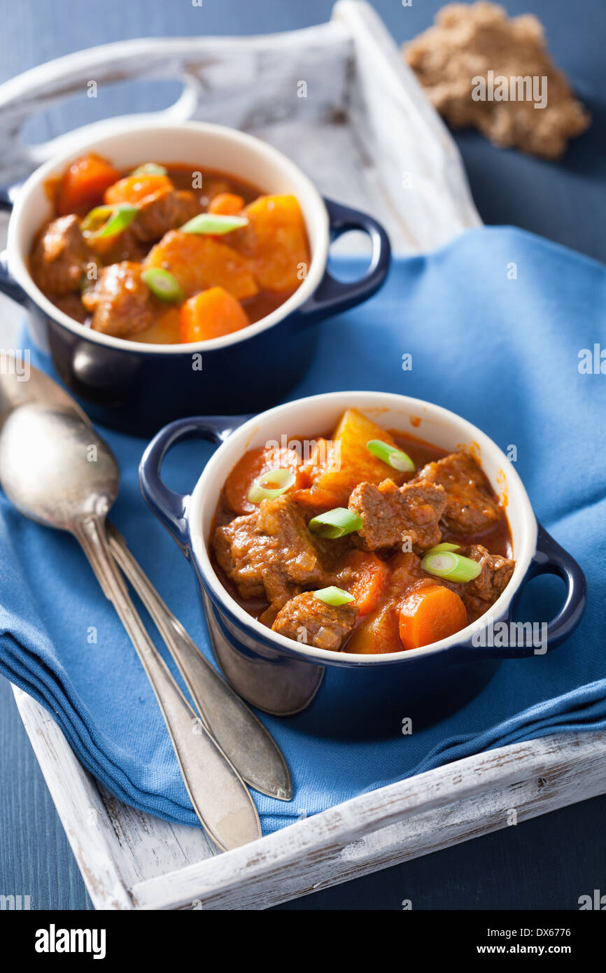 beef stew with potato and carrot in blue pots Stock Photo