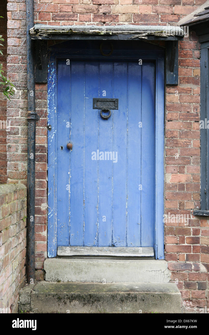 Faded blue painted Victorian house front door in Stratford upon Avon