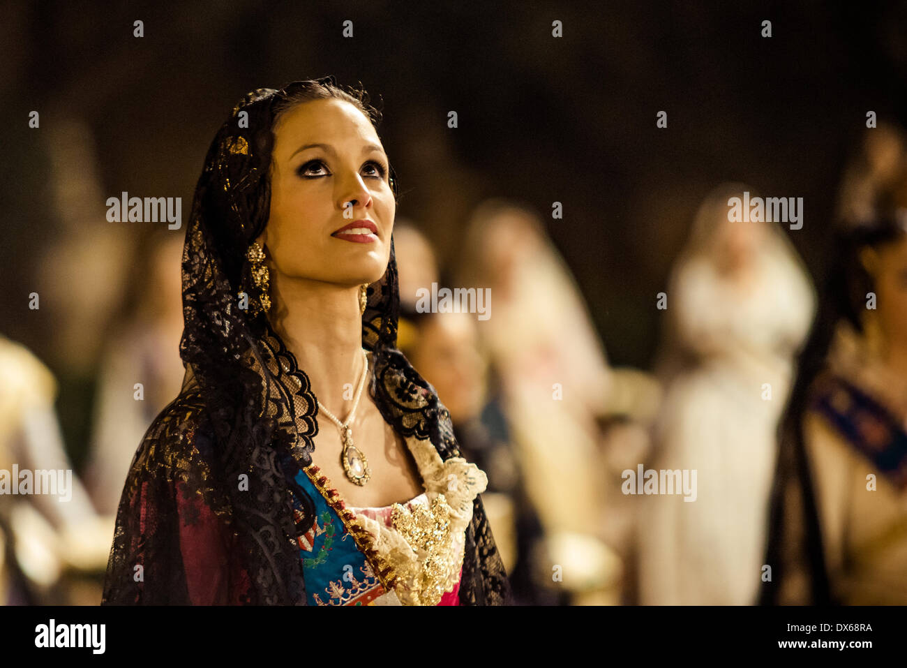 Valencia, Spain. March 18th, 2014: A emotional Fallera sees the image of the Virgin at the end of the walk of the Ofrenda Floral. Credit:  matthi/Alamy Live News Stock Photo