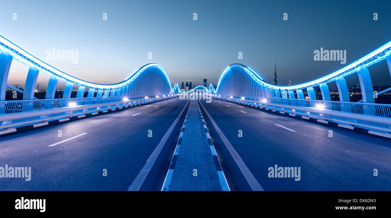 Modern architectural illuminated bridge at Meydan racecourse in Dubai United Arab Emirates Stock Photo