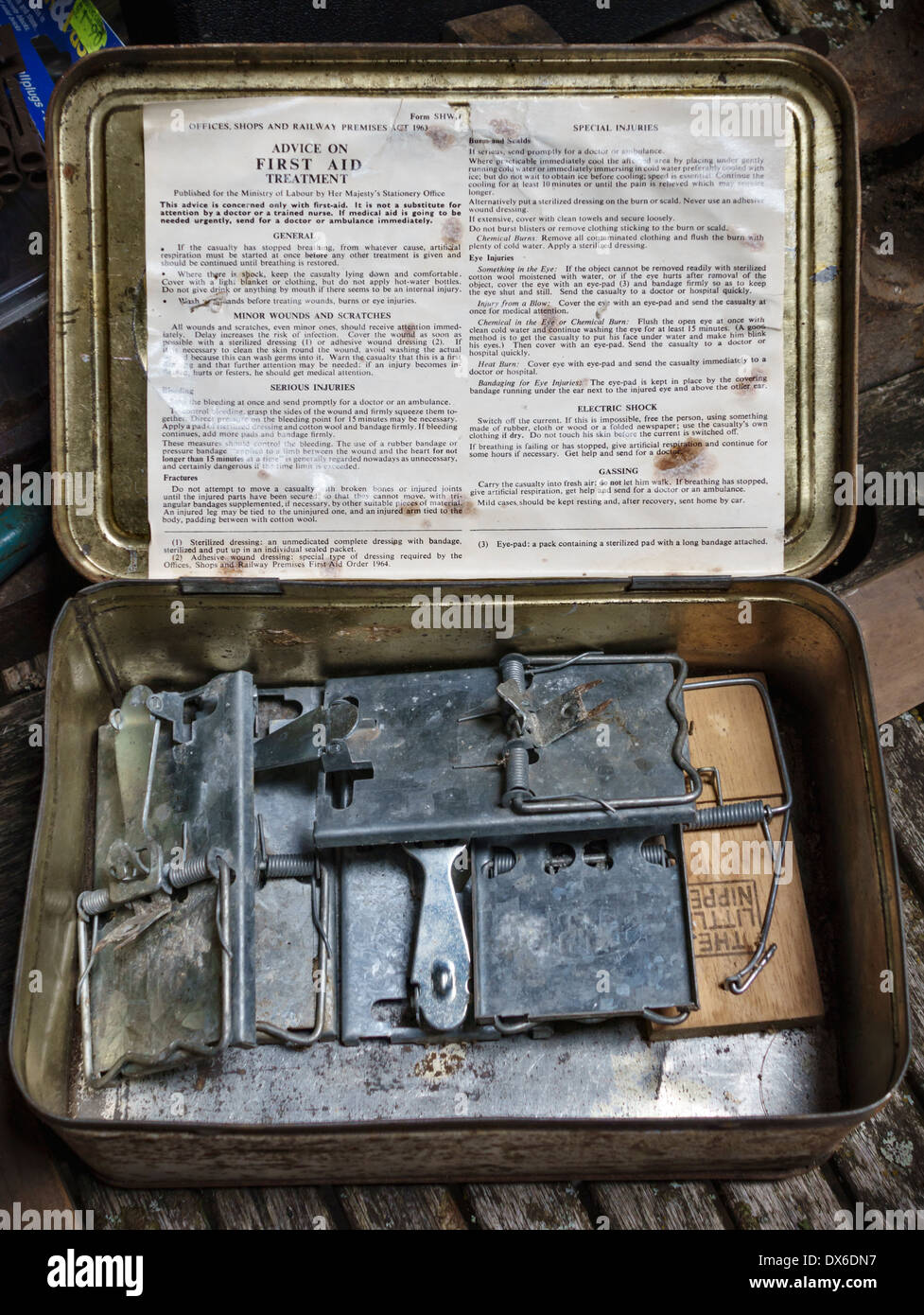 A first aid kit tin filled with old mouse traps, found in an old workshop, UK Stock Photo