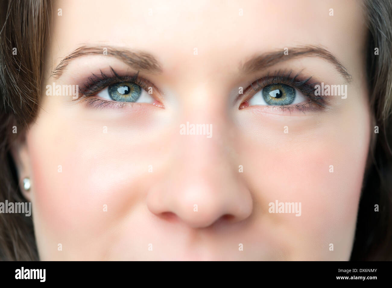 Closeup of young woman with blue eyes and nose Stock Photo