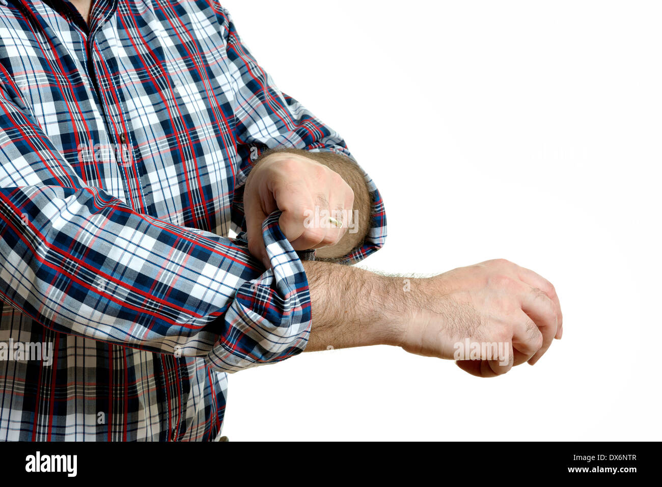 Man in a plaid shirt rolls up his sleeves, isolated on white background Stock Photo