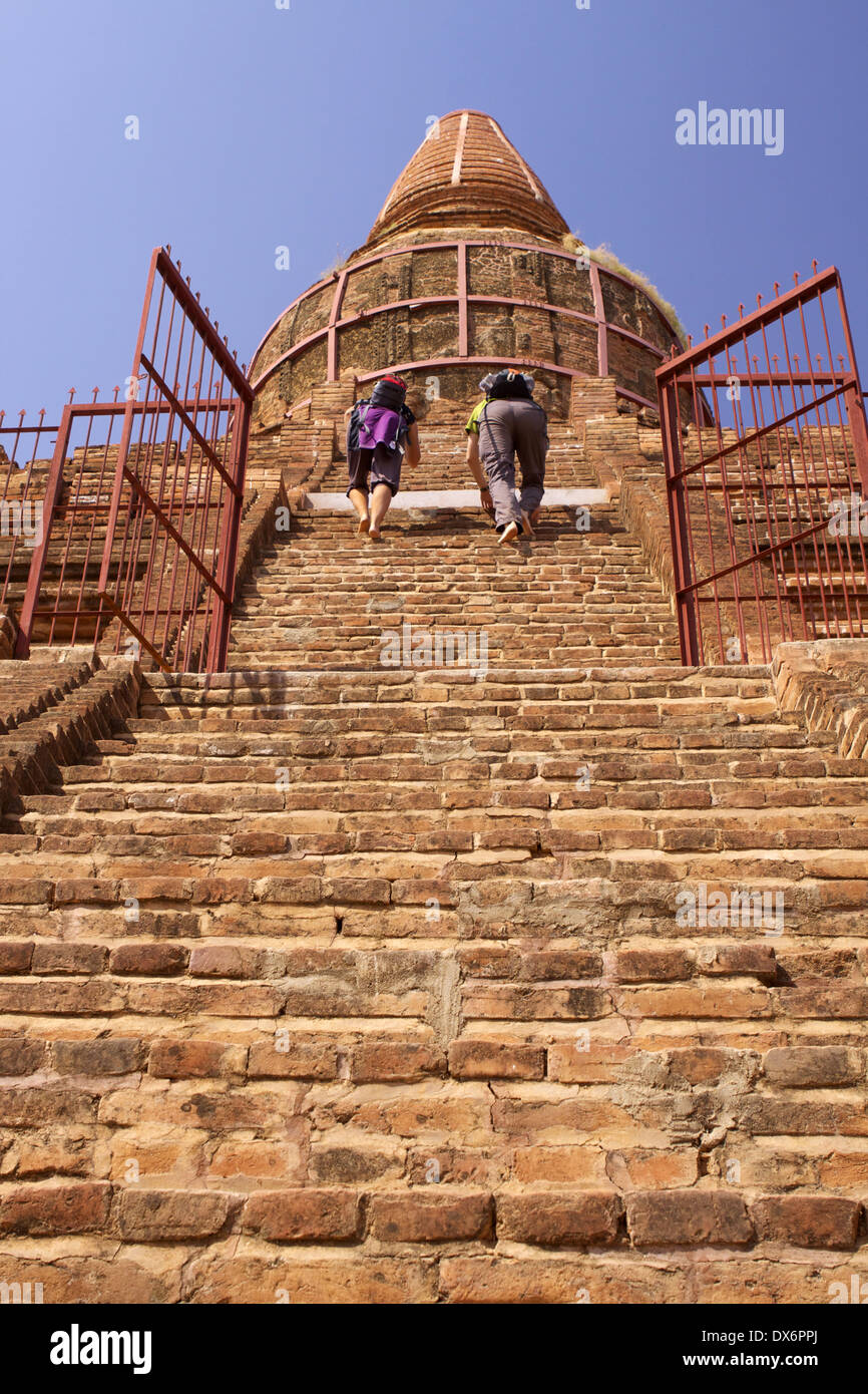 Visitors climb the steep hot brick steps unto the Buledi Temple Stock Photo