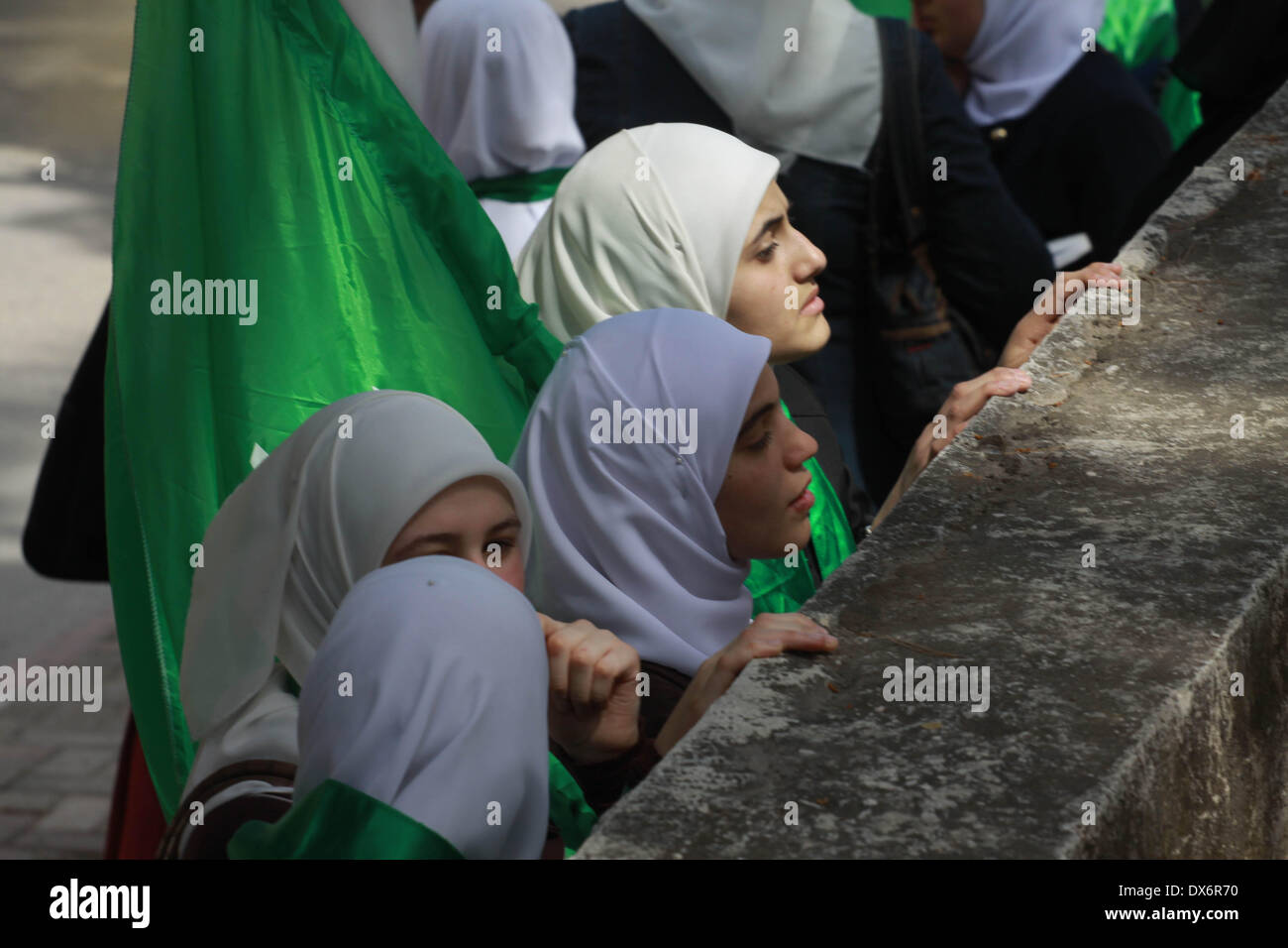 Nablus, West Bank, Palestinian Territory. 19th Mar, 2014. Palestinian women hold Hamas movement's flags during the funeral of Palestinian militant Mohammed Hanbali who was killed 11 years ago during a funeral in the West Bank city of Nablus, March 19, 2014. Since the late 1960s, Israel has withheld the bodies of hundreds of Palestinians. Their bodies are interred in numbered, rather than named, graves in four cemeteries created for that purpose, the biggest of which is located in the Jordan Valley Credit:  Nedal Eshtayah/APA Images/ZUMAPRESS.com/Alamy Live News Stock Photo