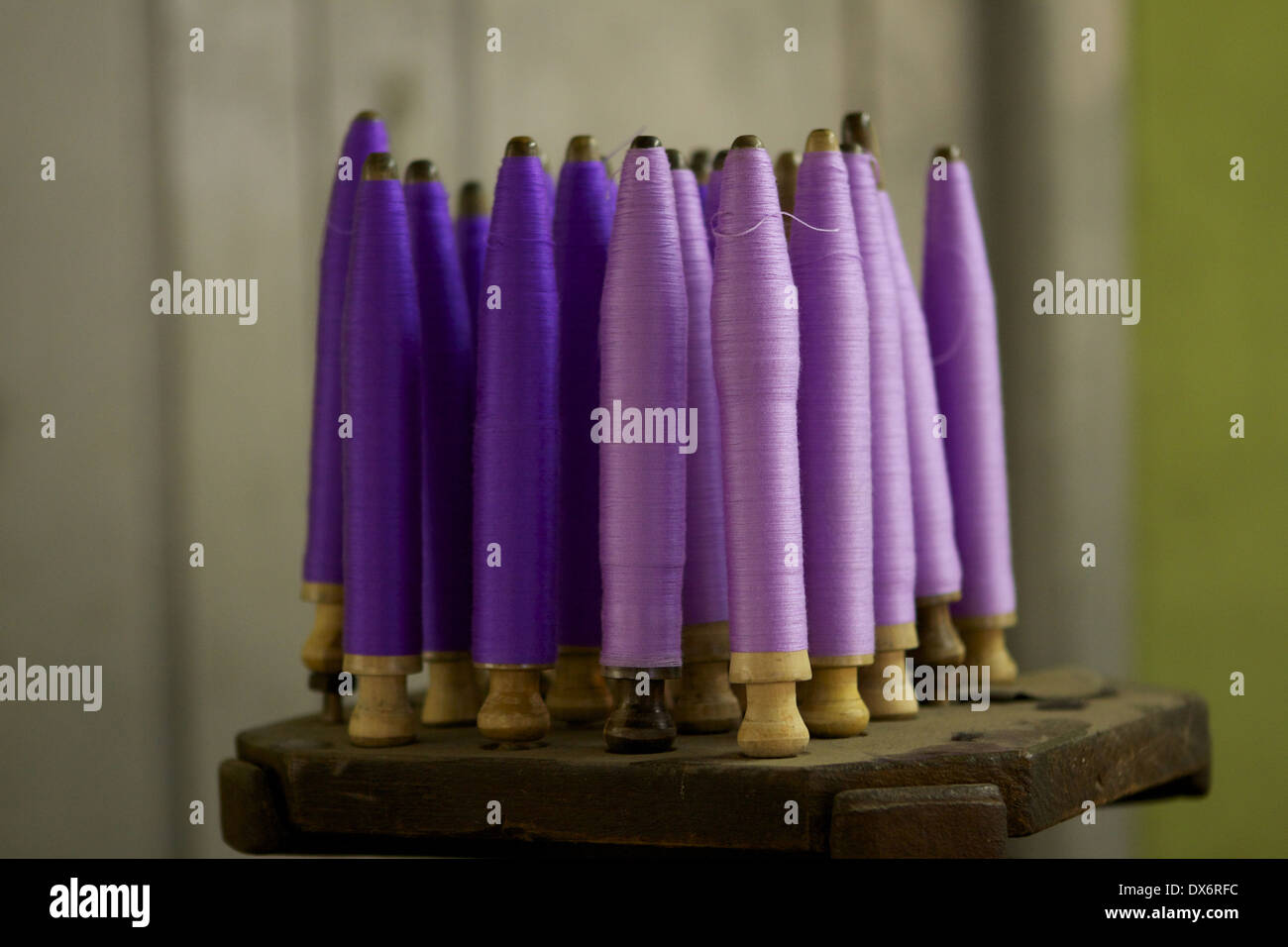 Spindles of purple & lilac coloured silk thread prior to being woven into fabric in a textile workshop in town of Amarapura, Stock Photo