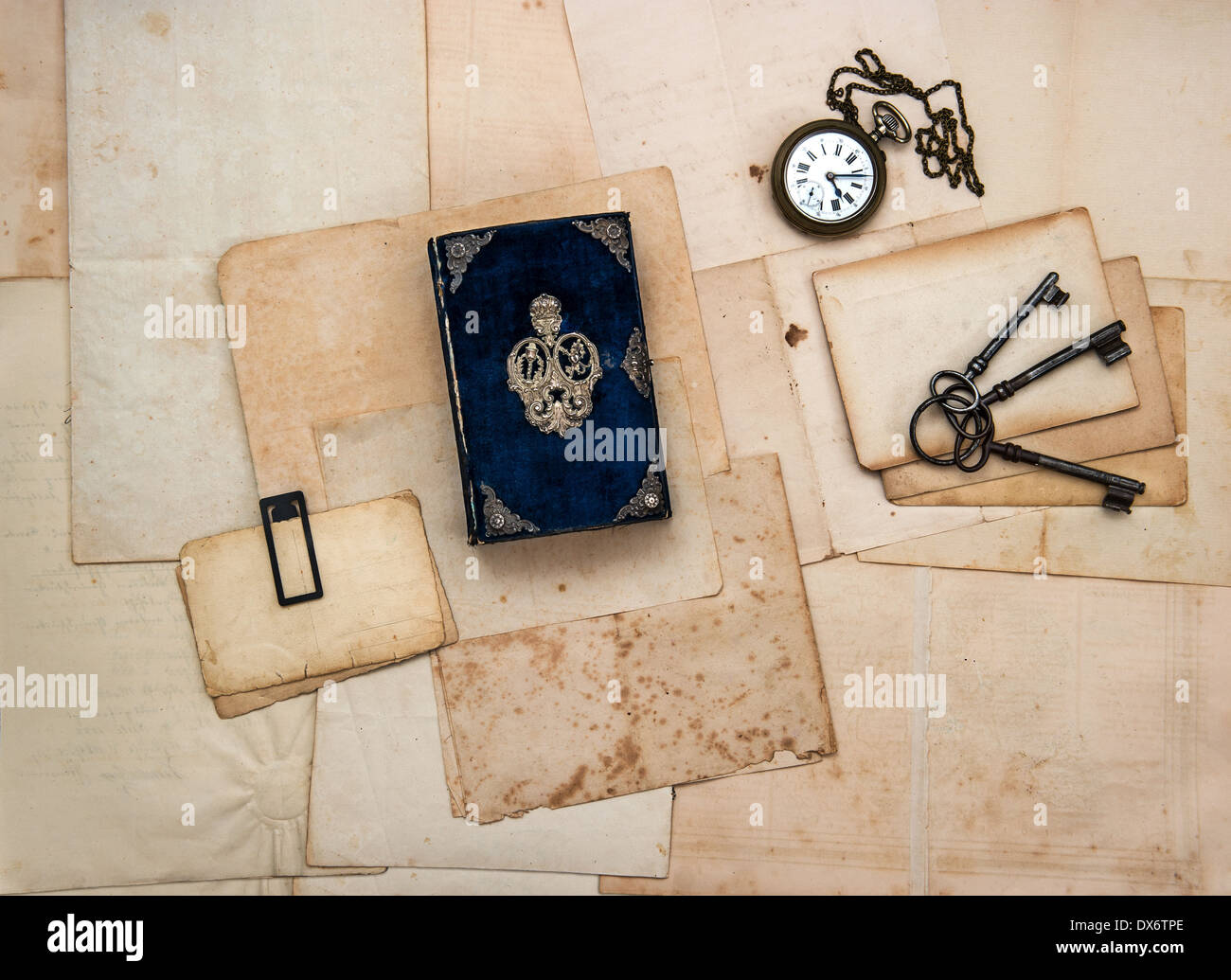 vintage accessories, keys, antique book, old letters and photos. nostalgic sentimental paper background Stock Photo