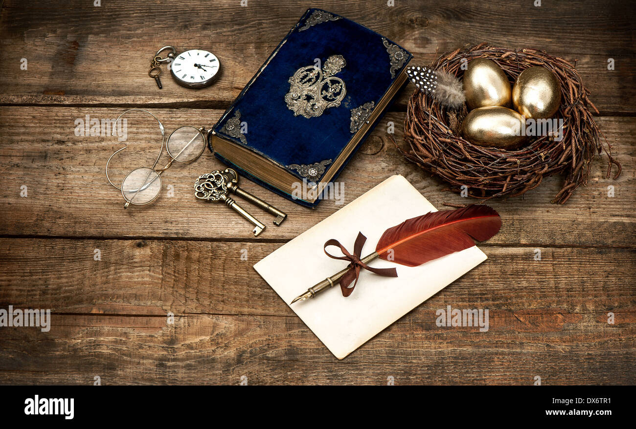 vintage easter still life composition. decoration with eggs and antique bible book Stock Photo