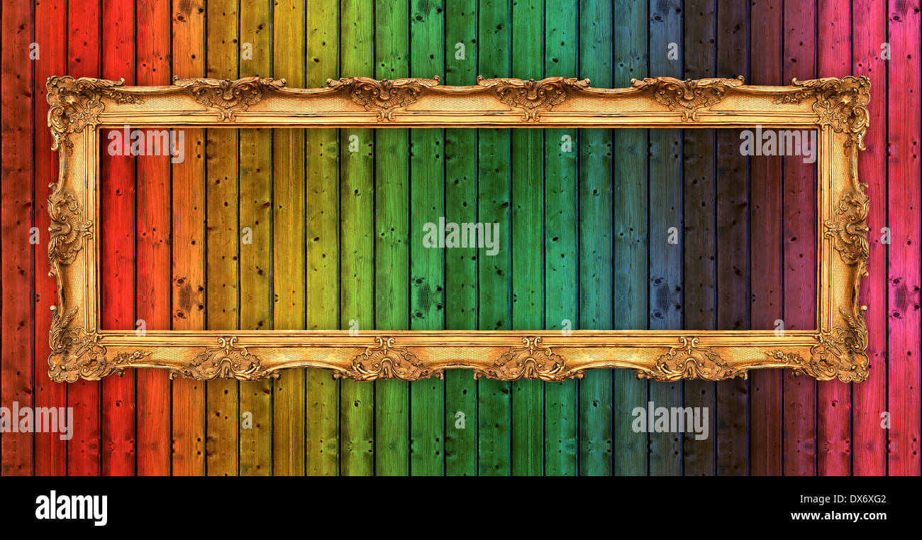 long old golden frame over colorful wooden wall. beautiful vintage background Stock Photo