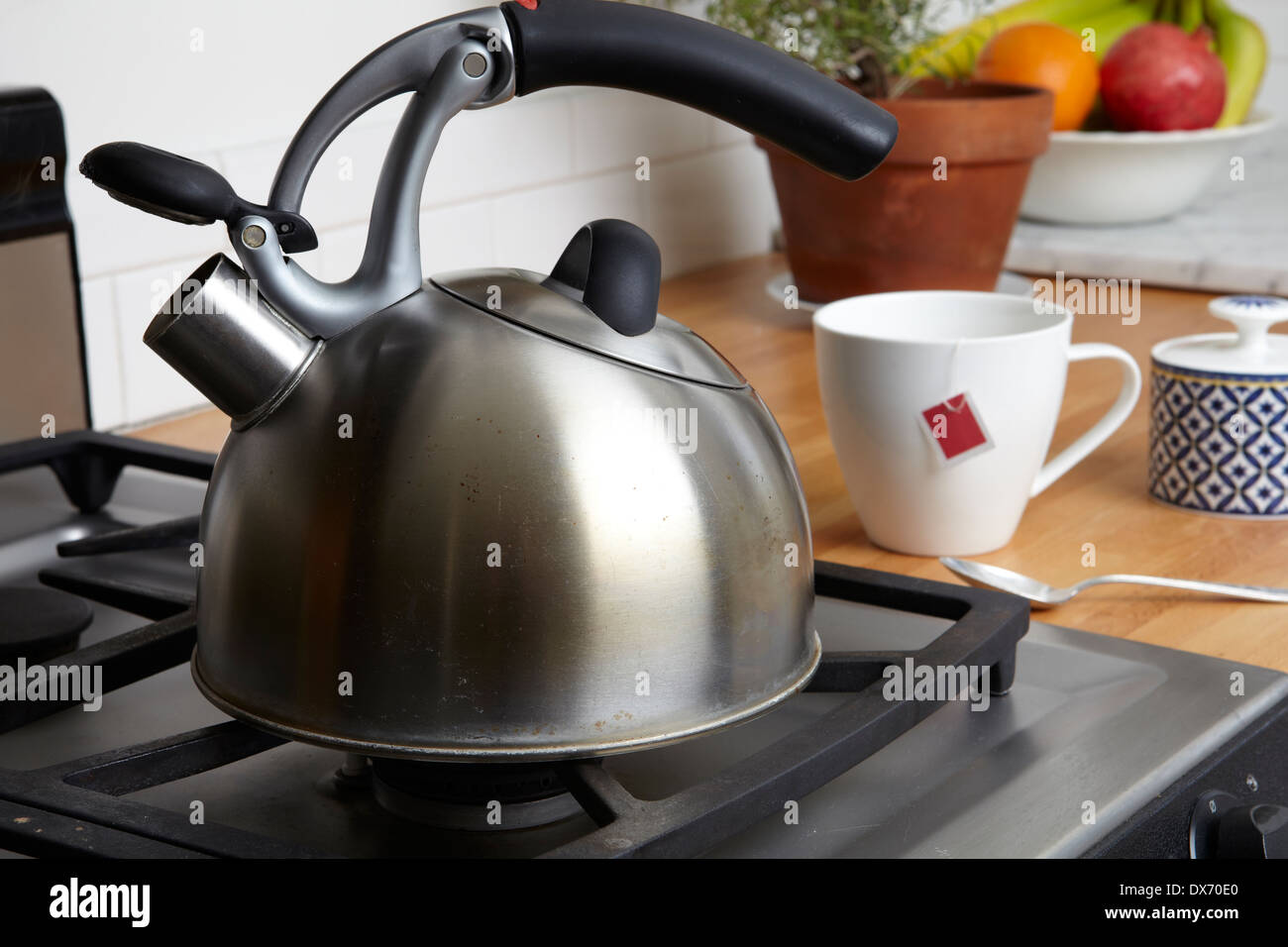 Bright steaming tea kettle stands on a kitchen countertop, ready to brew a  fresh cup of hot tea. Stock Illustration