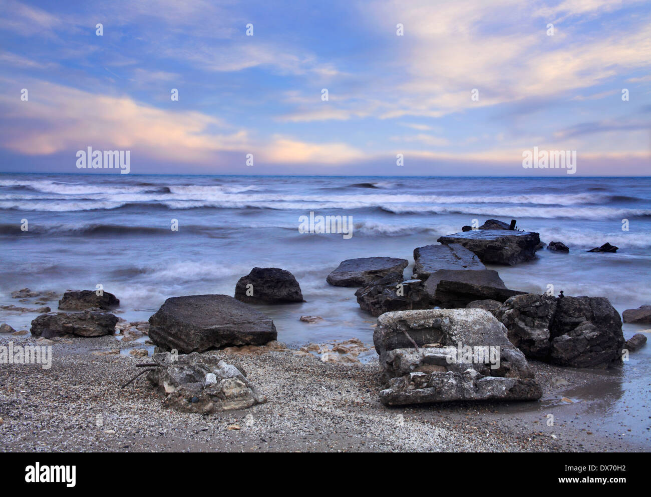 Boulders In The Lake Michigan Surf On A Cold And Rainy Early Spring Day At Wind Point, Racine Wisconsin, USA Stock Photo