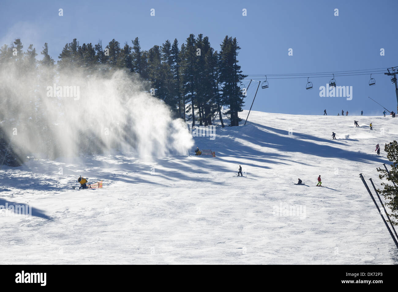 Snow cannon gun, artificial snow making machine on the slopes of a ski  resort, ski lift and piste Stock Photo - Alamy