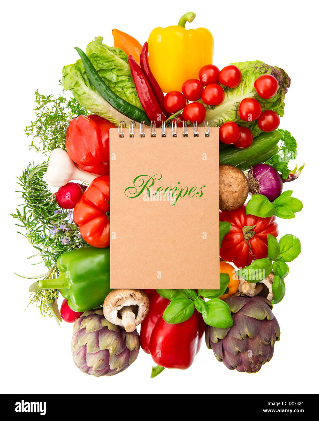 recipe book with fresh organic vegetables and herbs isolated on white background. raw food. healthy nutrition ingredients Stock Photo