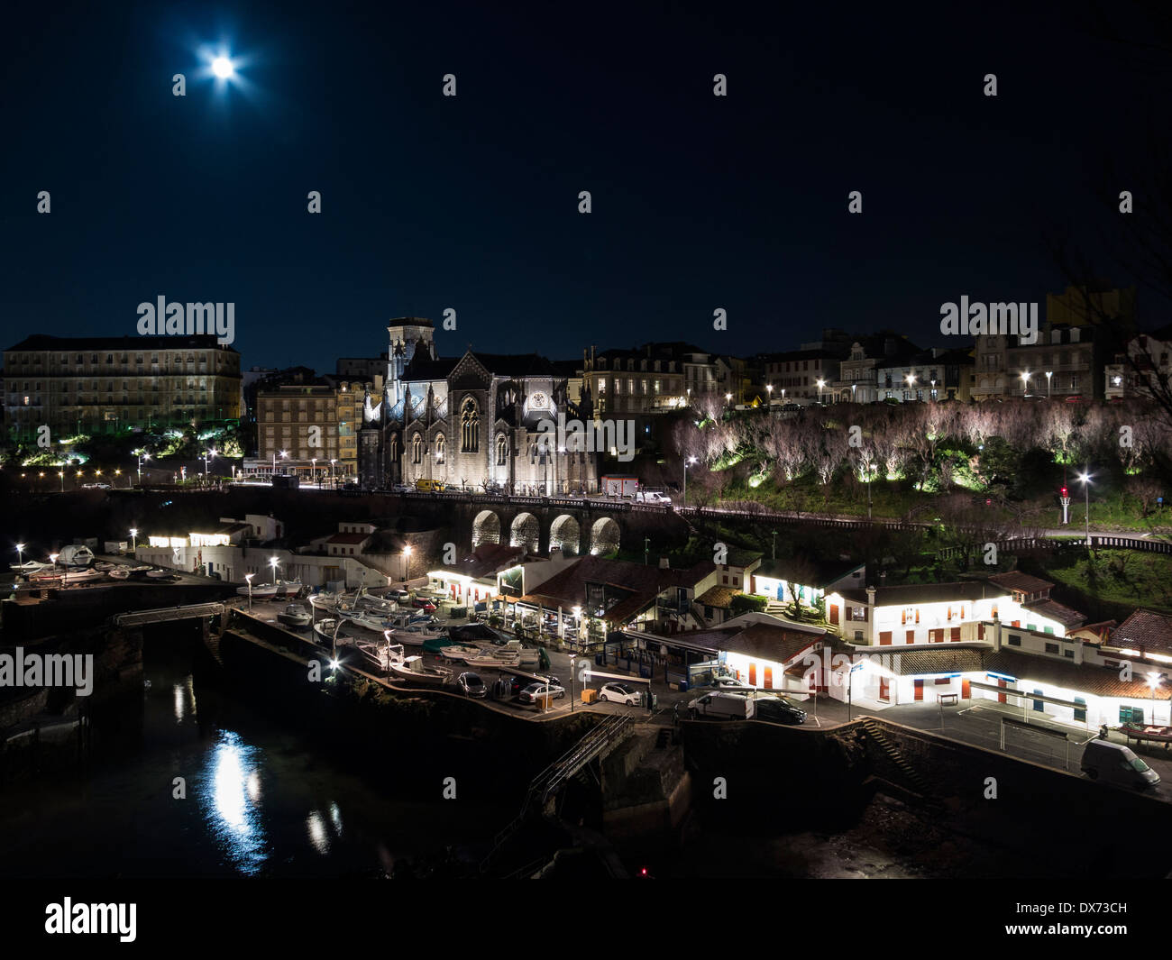 Biarritz 'Port des Pêcheurs' lit at night by a bright moon. Stock Photo