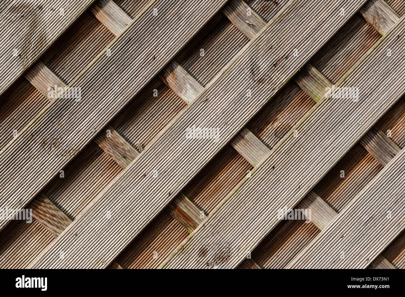 Wooden fence paneling, diagonal shapes, portrait, side-lit. Stock Photo
