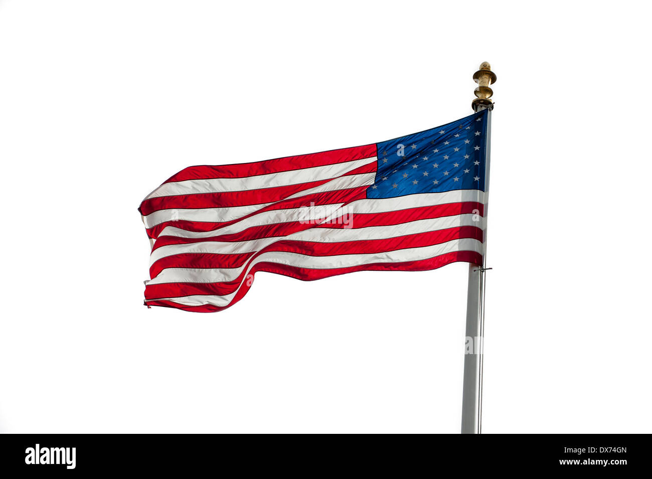 American flag showing US Stars and Stripes blowing in the wind on white background Stock Photo