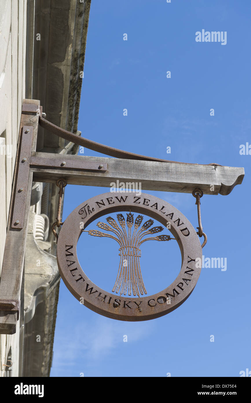 A whisky distillers sign in Harbour Street in the historic district. Stock Photo