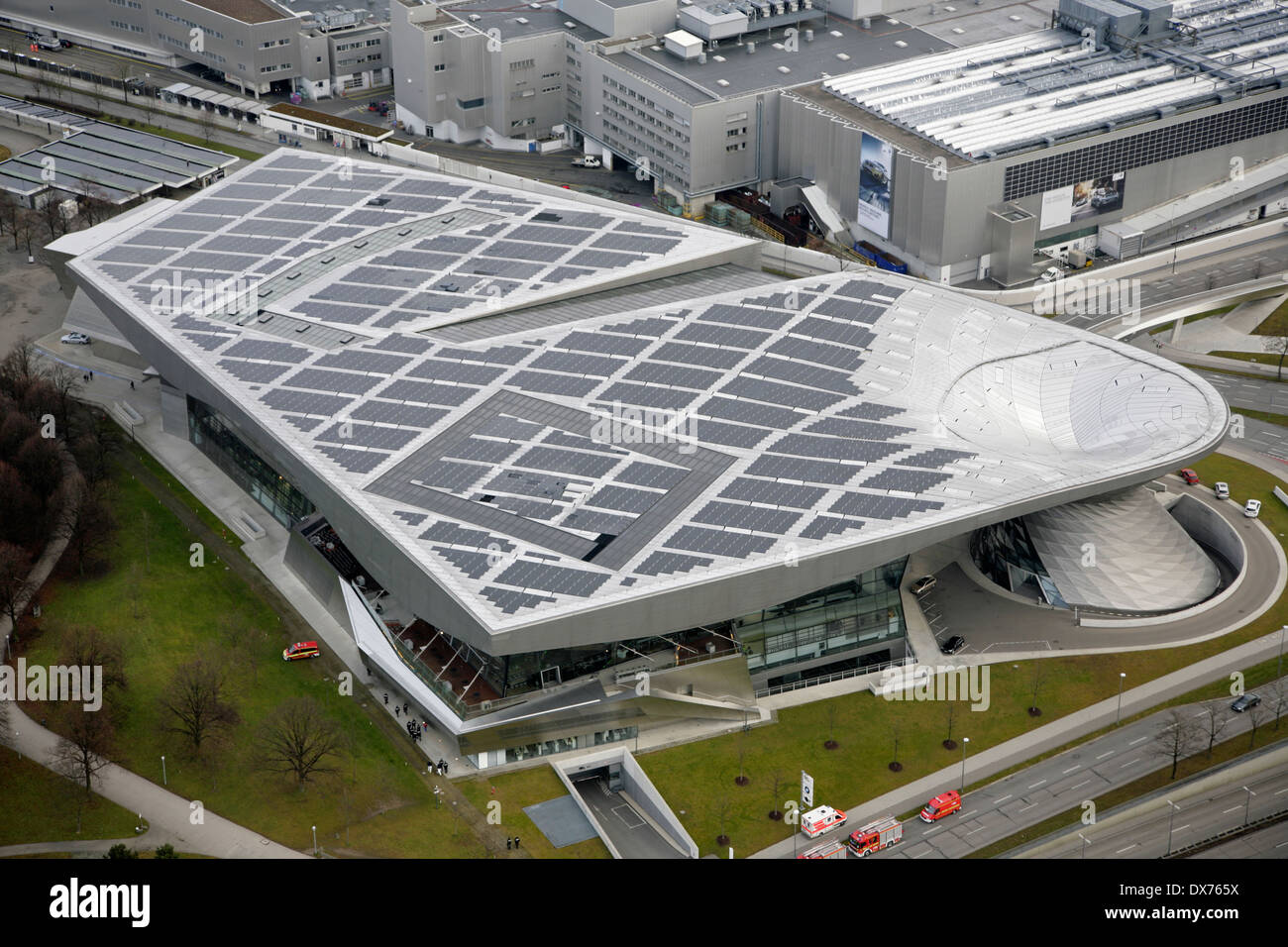 Solar panels on the roof of BMW-Welt or BMW World, Munich, Germany with the BMW factory behind. Stock Photo