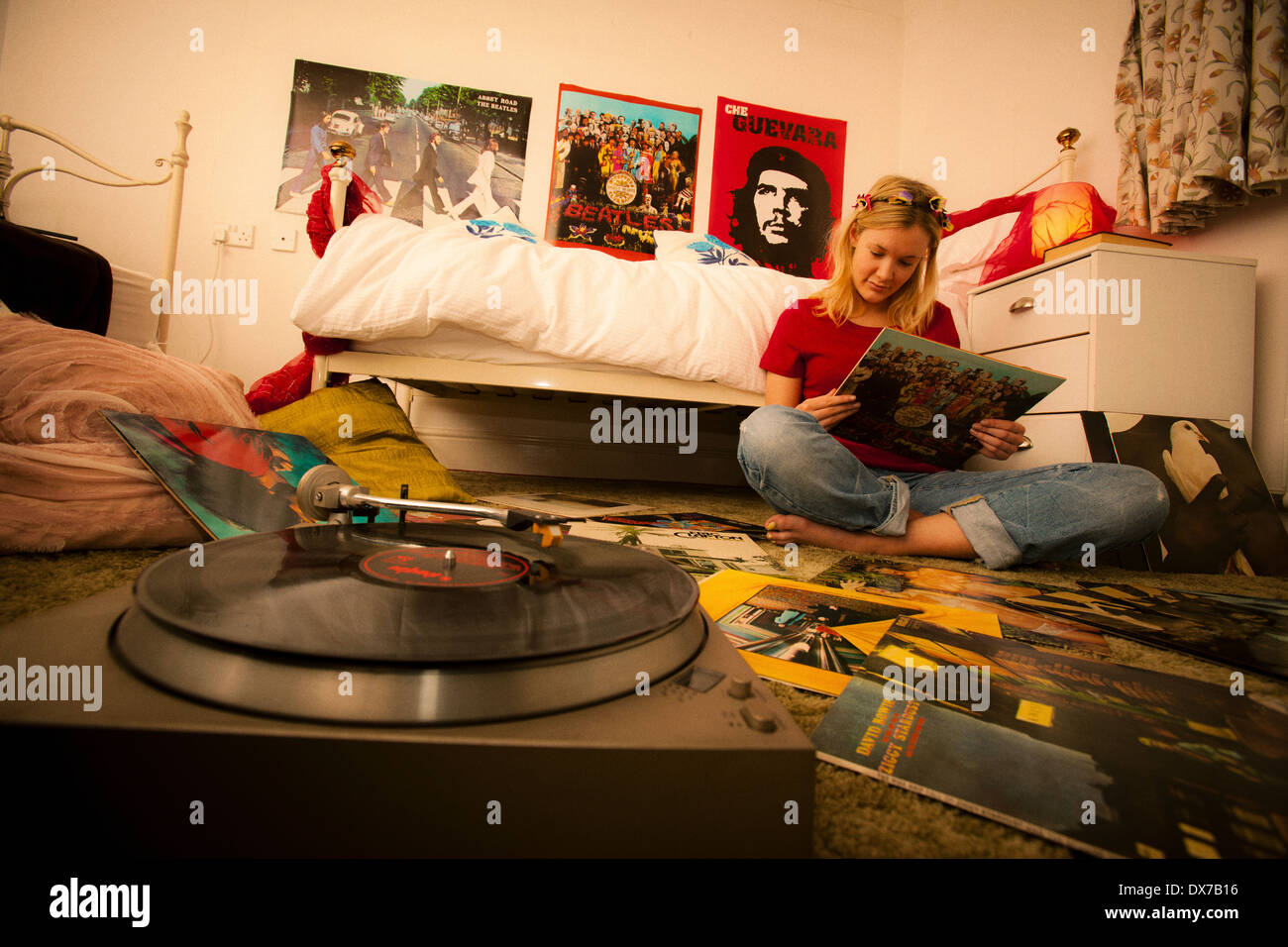 Pretty teenage girl in her bedroom enjoying her record collection Stock Photo