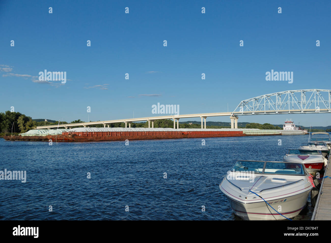 Grain barges pushed upstream on Mississippi River in Wabasha, MN. Stock Photo