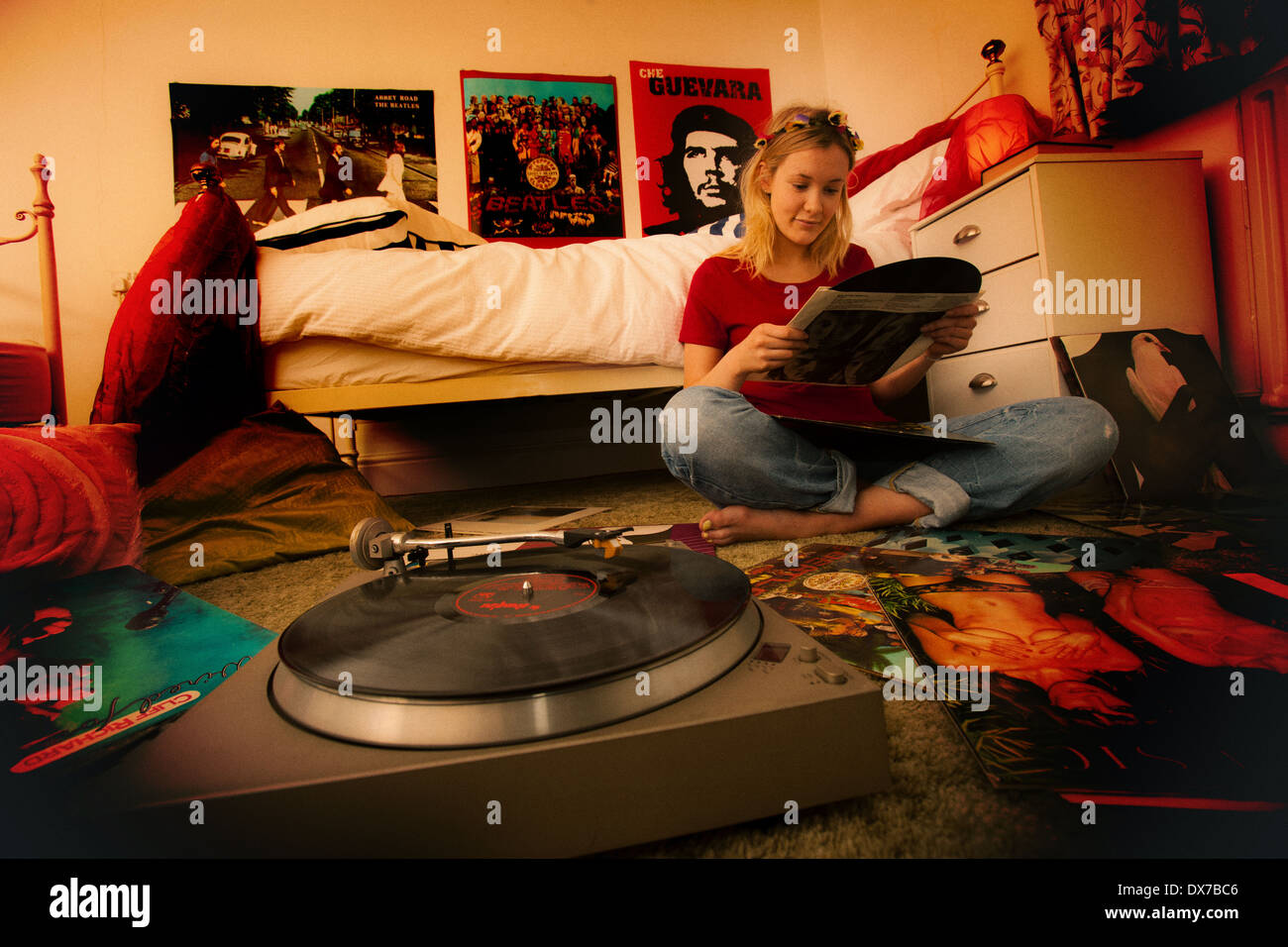 Pretty teenage girl in her bedroom enjoying her record collection Stock Photo