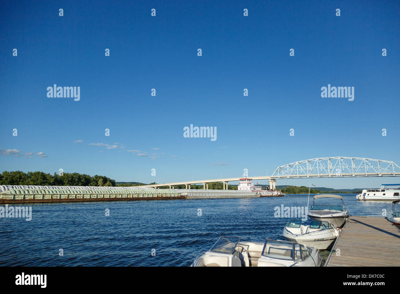 Grain barges pushed upstream on Mississippi River in Wabasha, MN. Stock Photo
