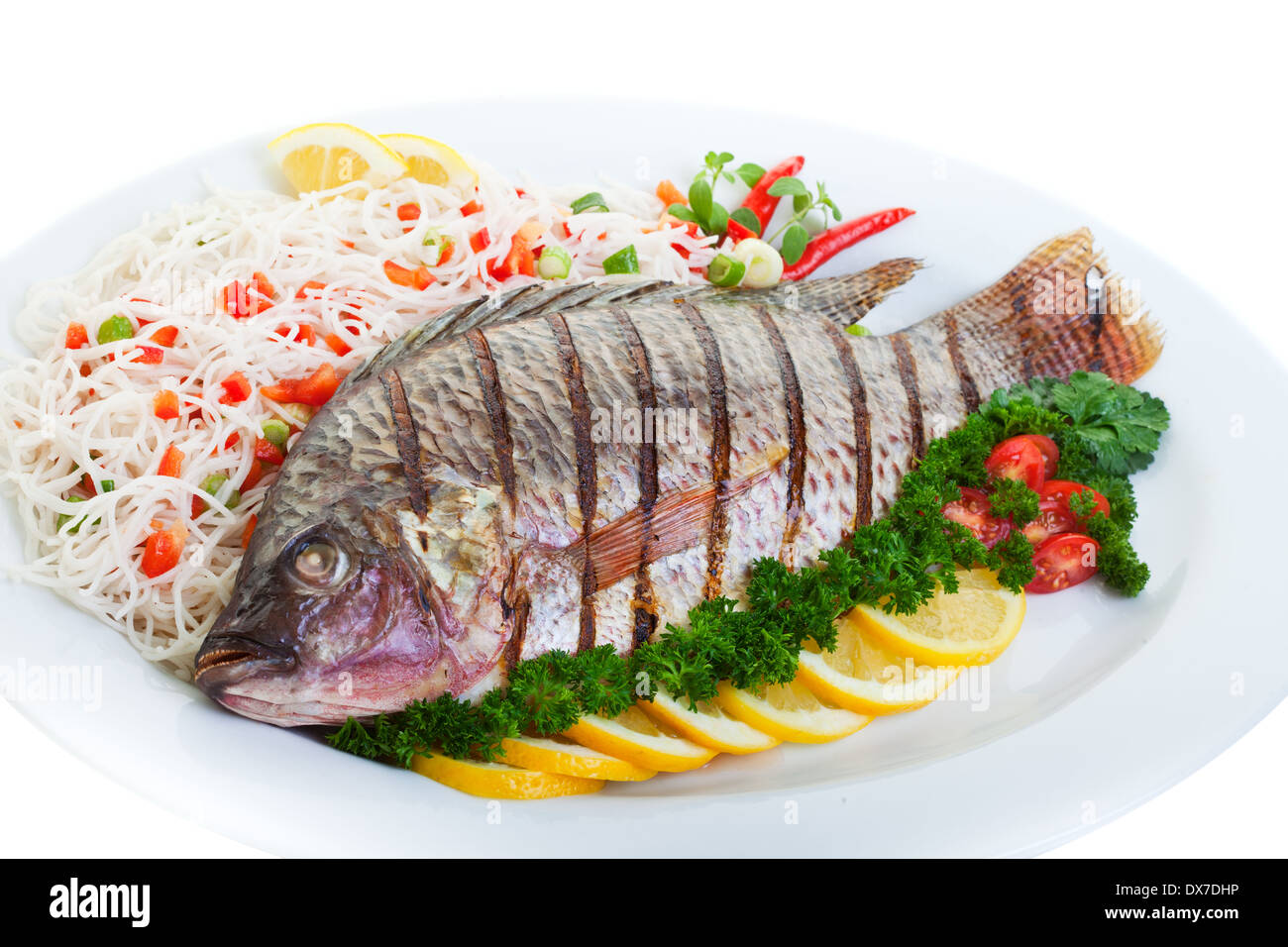 Grilled tilapia served with pasta and vegetables Stock Photo Alamy