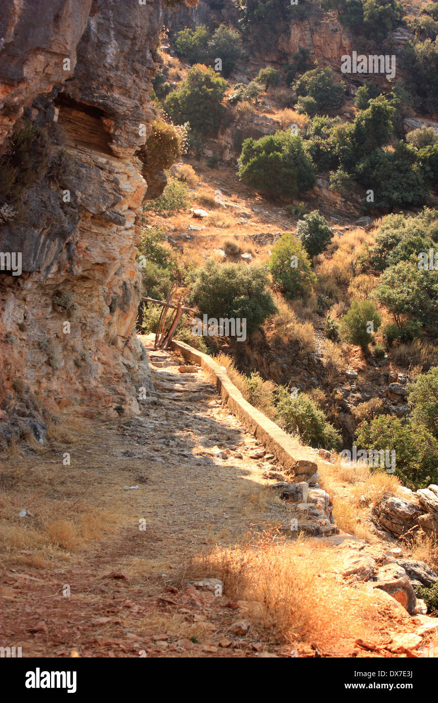 a view of a rocky footpath through the mountains along the Lycian way which overlooks Oludeniz in Turkey Stock Photo