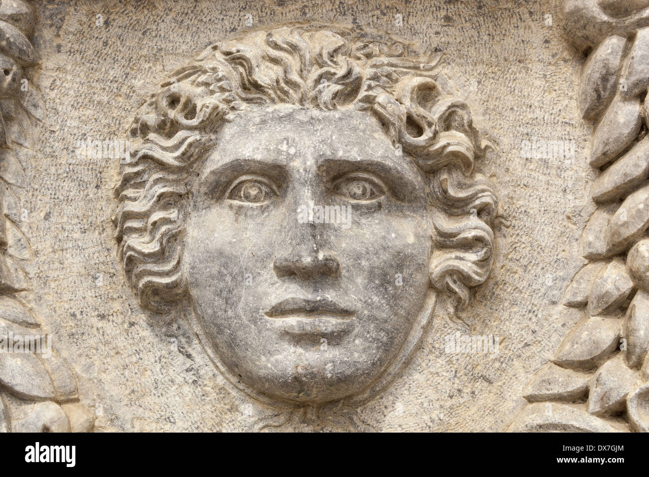 Carved stone face detail on a sarcophagus at The Catacombs of Kom El Shuqafa, Alexandria, Egypt Stock Photo