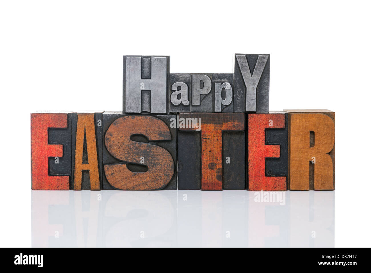 Words Happy Easter in old metal and wooden letterpress isolated on a white bcakground. Stock Photo