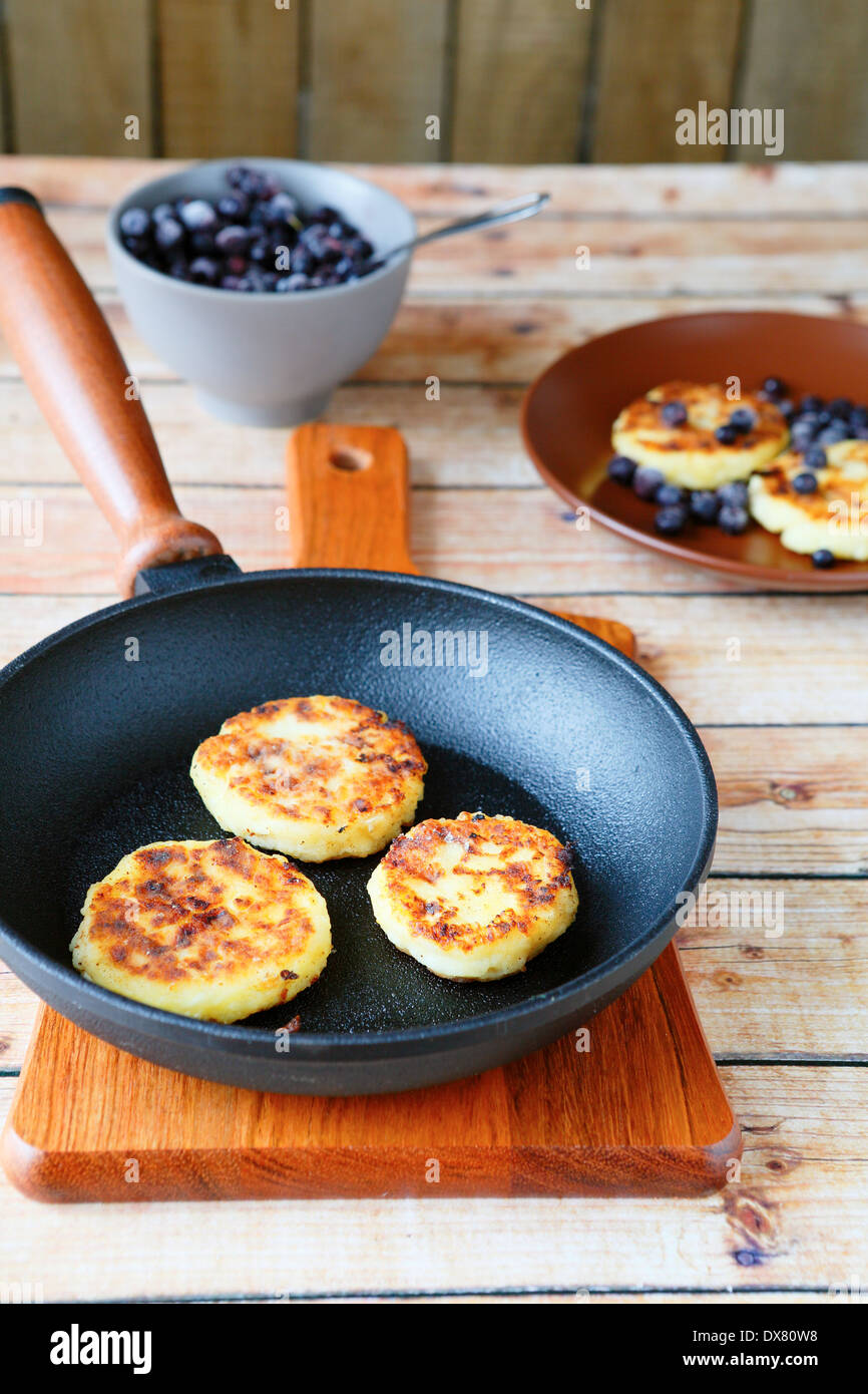 pancakes of cottage cheese in a pan, food closeup Stock Photo