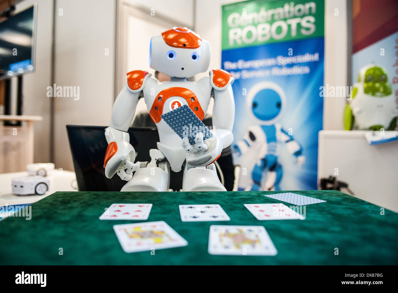 Lyon, France. 19th Mar, 2014. NAO Robot by Aldebaran plays poker (software developed by Generation Robots) at Innorobo 2014, the 4th international trade show on service robotics. Credit:  Piero Cruciatti/Alamy Live News Stock Photo