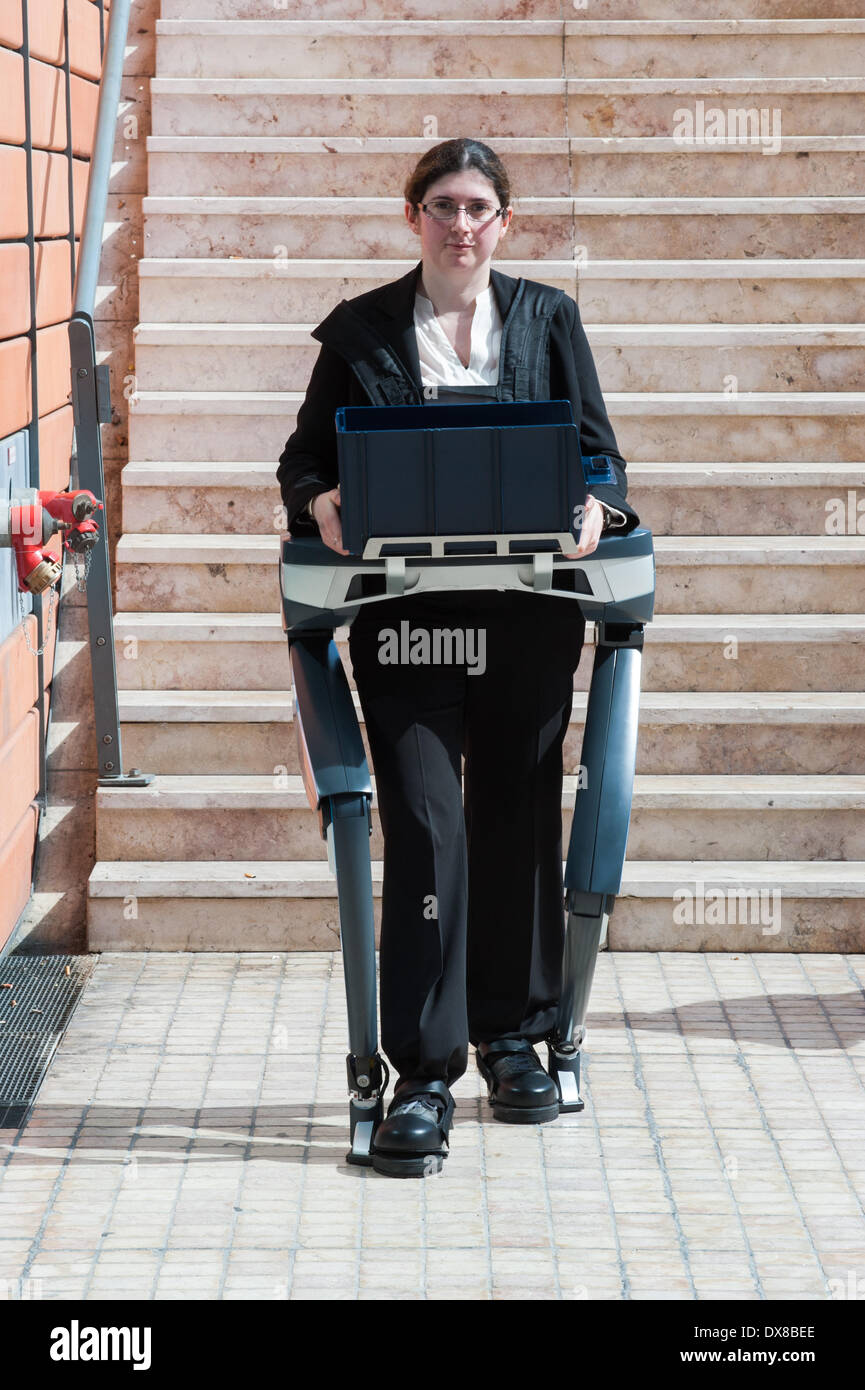 Lyon, France. 19th Mar, 2014. a woman demos the exoskeleton prototype  Hercule V.3 by RB 3D at Innorobo 2014, the 4th international trade show on service robotics. Credit:  Piero Cruciatti/Alamy Live News Stock Photo