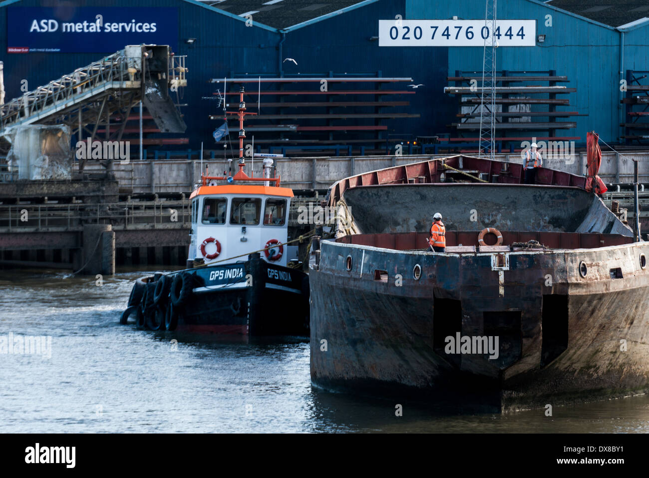 Working barges and tugboats on the River Thames in East London Stock