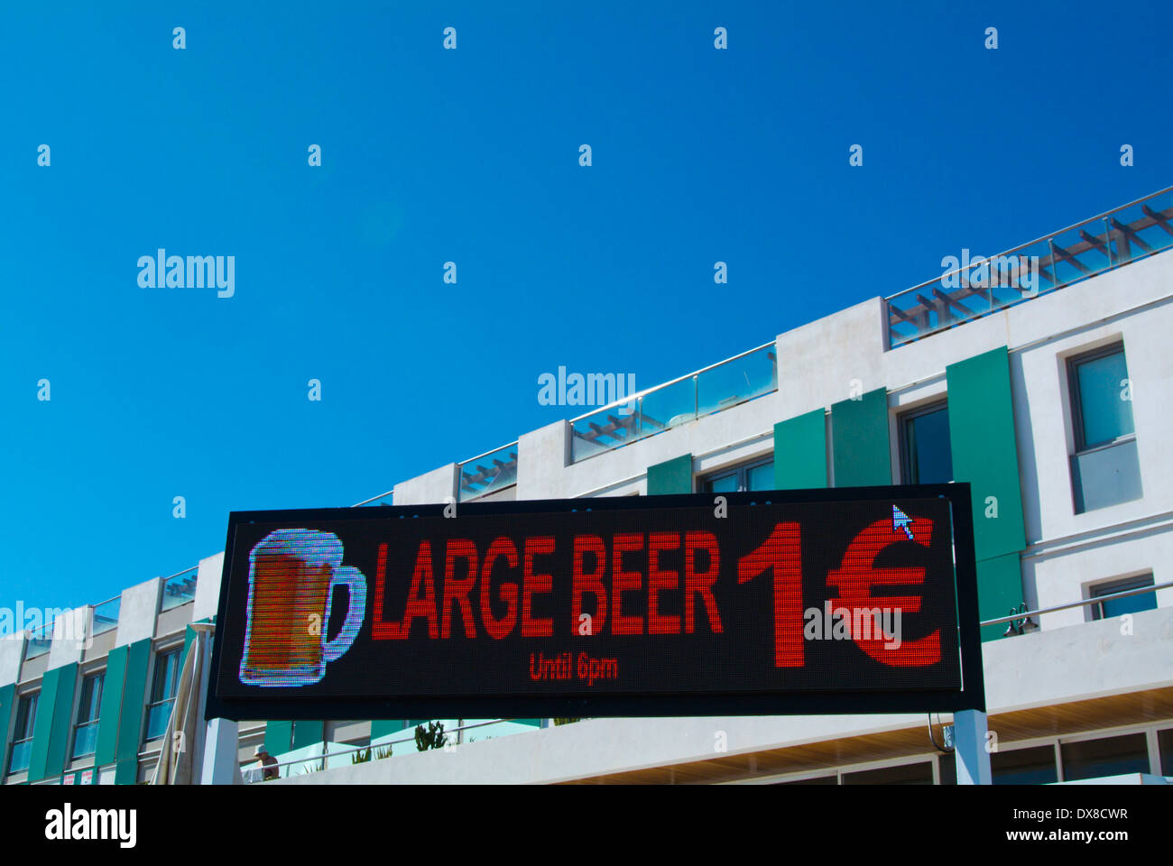 Sign advertising happy hour beer, Paseo Maritimo seaside promenade