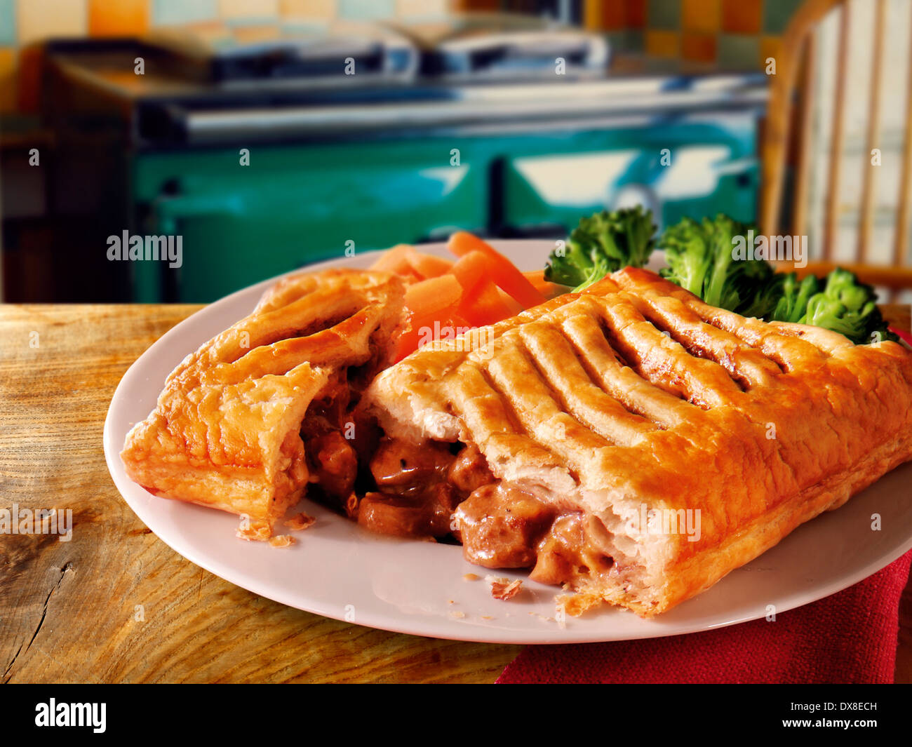Traditional British beef pastry pie served on a white plate on a table