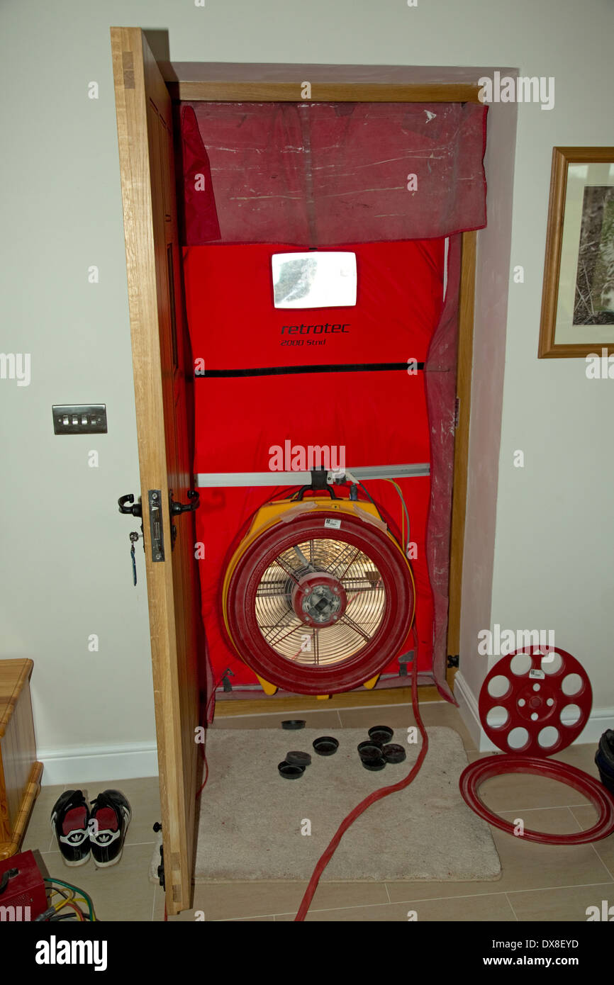 Air test fan installed in front door opening testing airtightness Stock