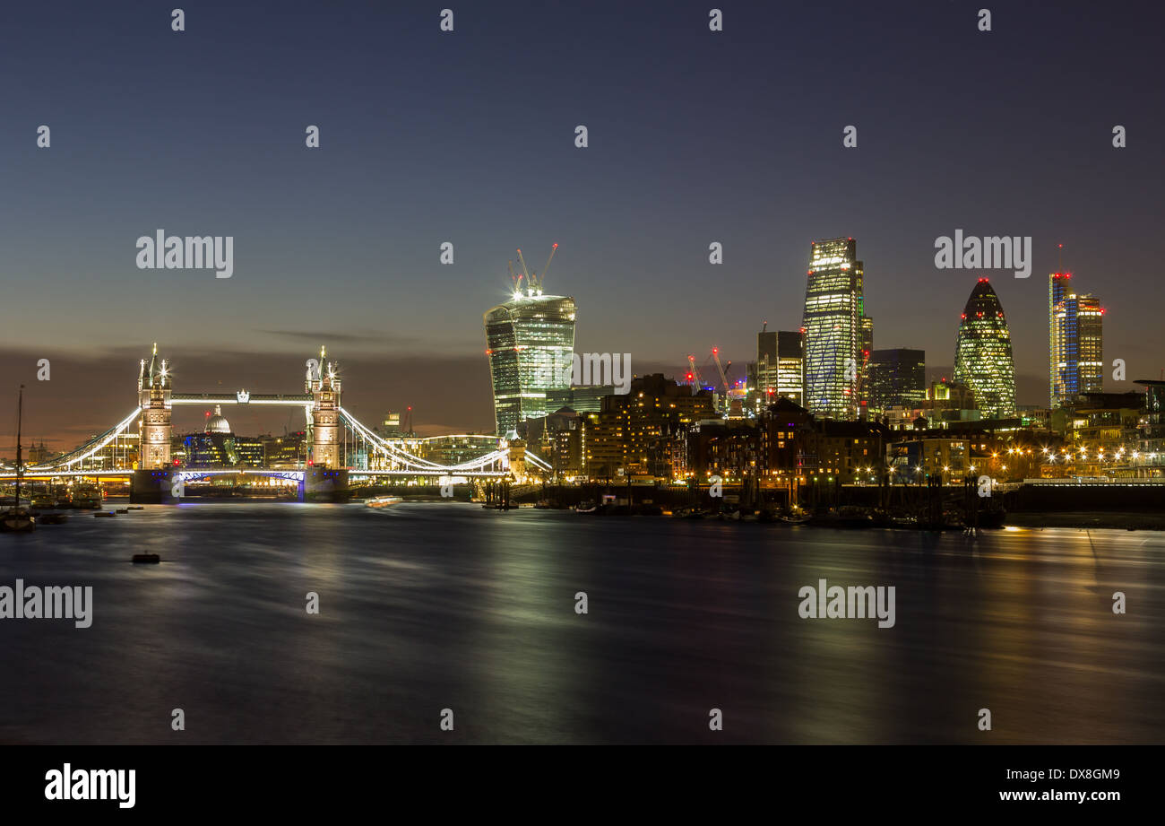 London City and Tower Bridge at Night from across the River Thames Stock Photo