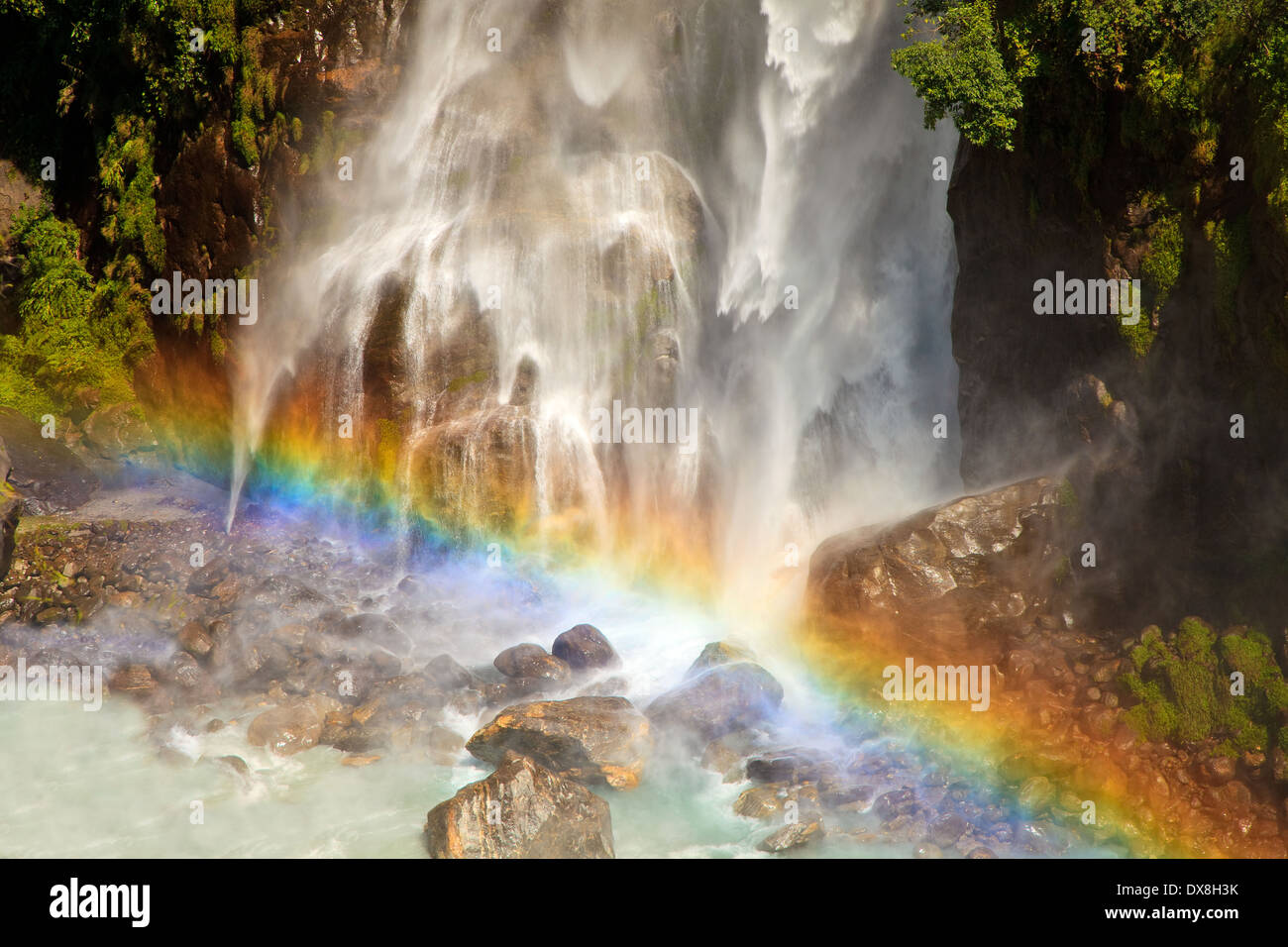 Waterfall with rainbow in Himalaya mountains, Nepal. Stock Photo