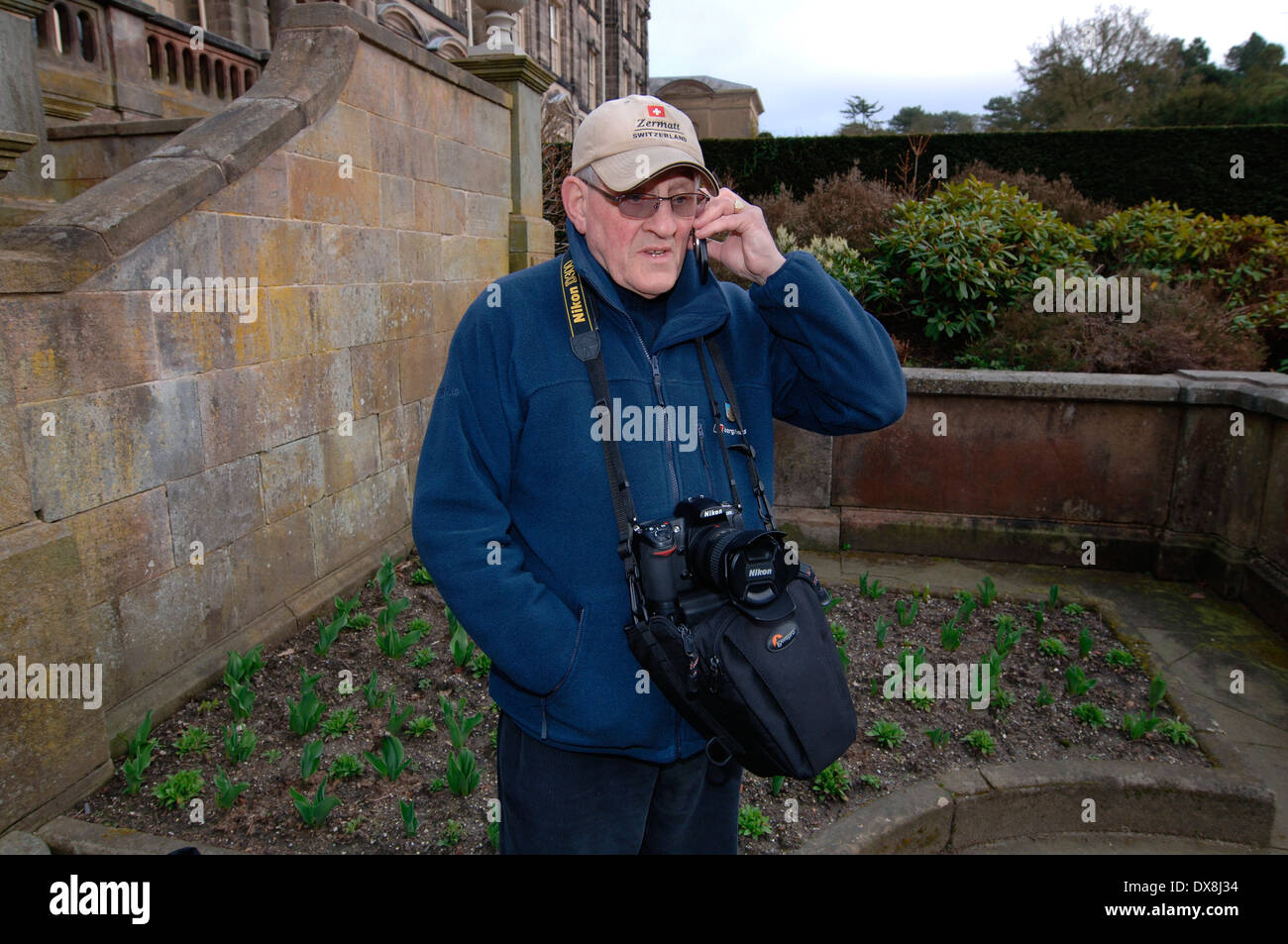 A Photographer Using His Mobile Phone.4.. Stock Photo