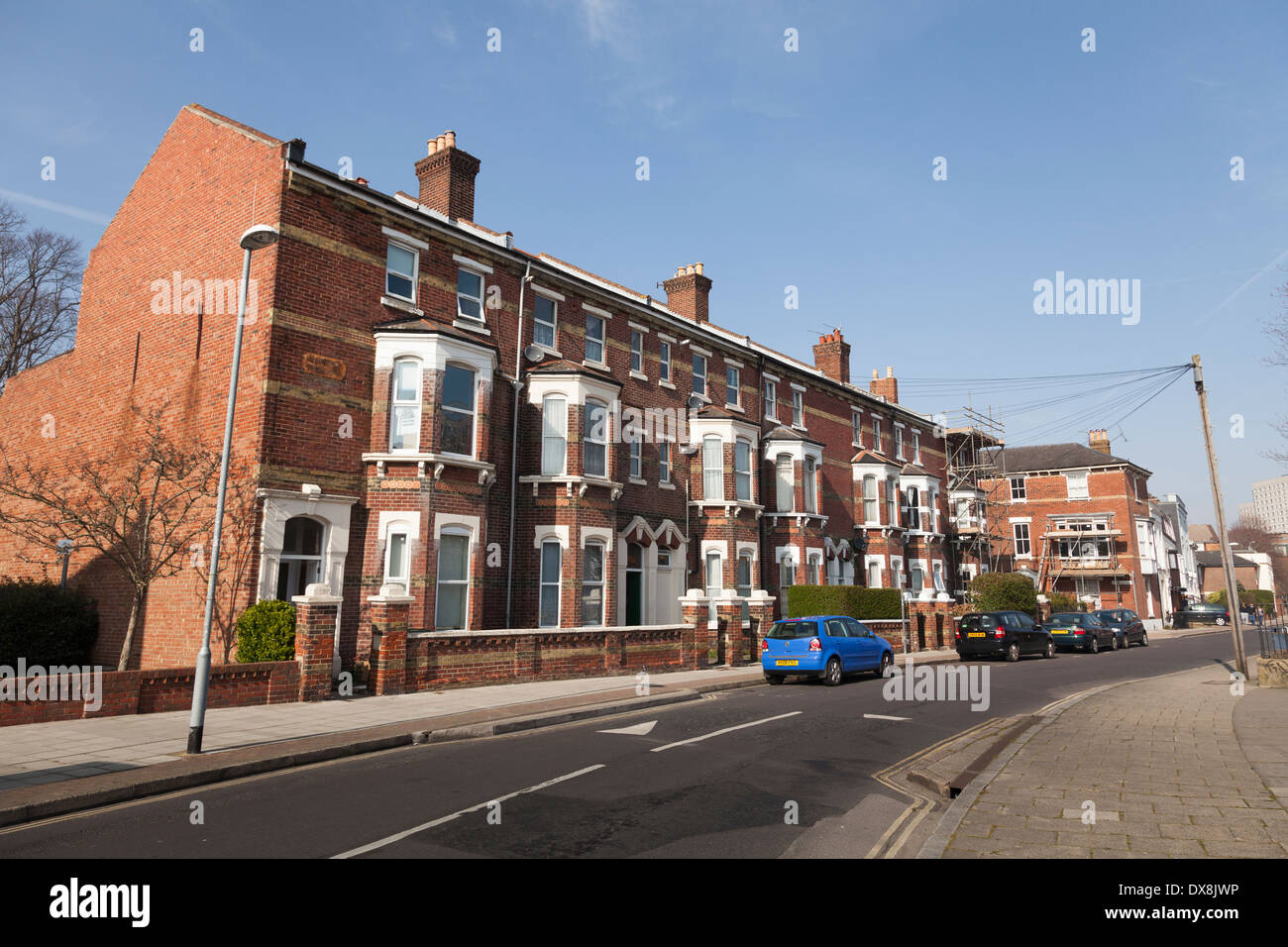 Three storey terrace houses with bay windows and front gardens Stock